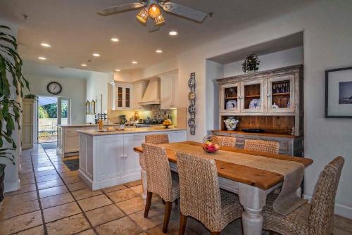 a large kitchen with a wooden table and chairs at Luxurious Mykonos in Santa Barbara with Outdoor Deck Short Bike Ride to Beach in Santa Barbara