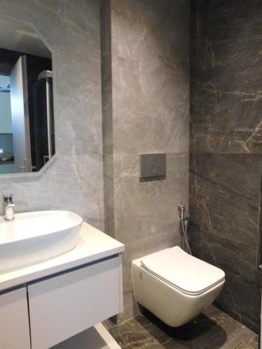 a bathroom with a white toilet and a sink at Kalon Gaia NOSTOS in Karistos
