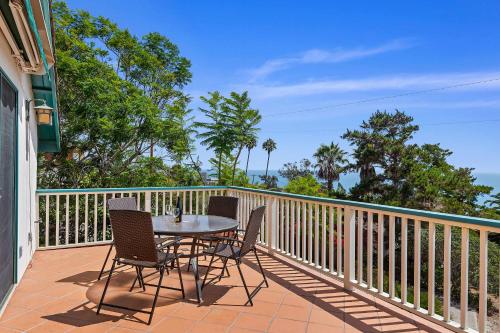 a patio with a table and chairs on a balcony at Blue Ocean View Retreat - Minutes to Beach in Summerland