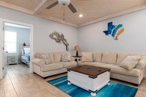 a living room with a couch and a table at Modern Comfort 3 Bedroom Pets in Port Aransas