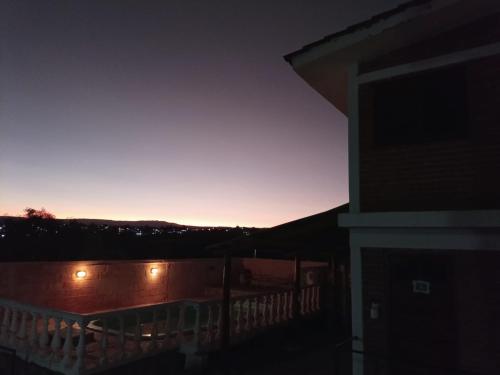 a view of the sunset from the balcony of a house at Cabañas Guer Aike in Villa Carlos Paz