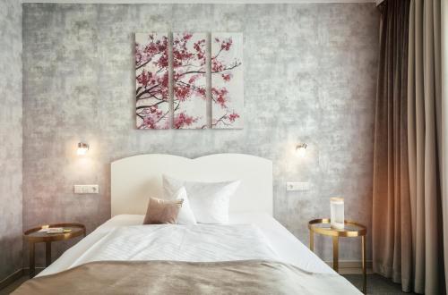a bedroom with a bed and two paintings on the wall at Hotel Traube Revital in Wurmlingen