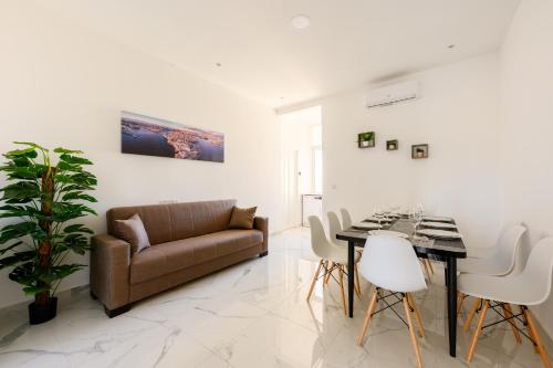 a living room with a couch and a table at F8-3 Sliema bedroom for 2 in Sliema