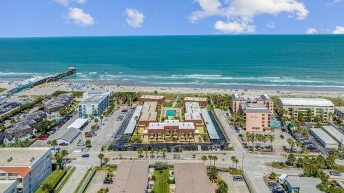 an aerial view of a resort near the beach at 2BR Sleeps 6 Pool BBQ Steps to Beach Pier Downtown in Cocoa Beach