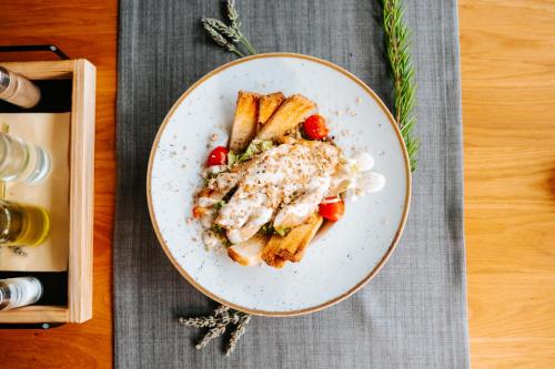 a plate of food on a table with some food at Hotel GOLD JET Bihać in Bihać