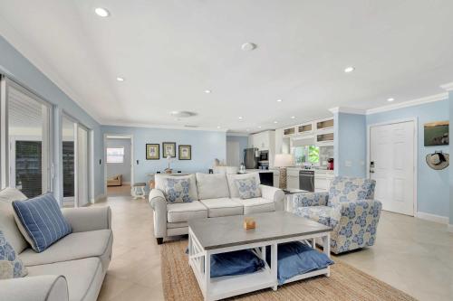 a living room with a couch and chairs and a table at Dolphin Villa - Private Pool in West Palm Beach