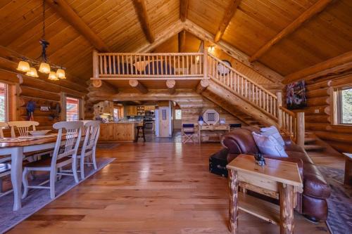 a living room with a staircase in a log cabin at Maggies Cabin - Enjoy a Slice of Paradise in Rexford Montana in Rexford
