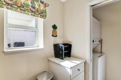 a bathroom with a toilet and a window at Mango House - Immaculate 3 BDR in Boynton Beach in Boynton Beach