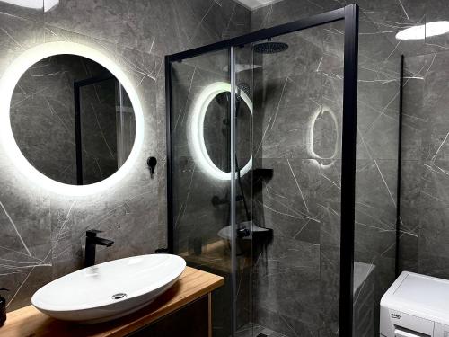 a bathroom with a sink and a shower at MK Apartments PP in Poprad