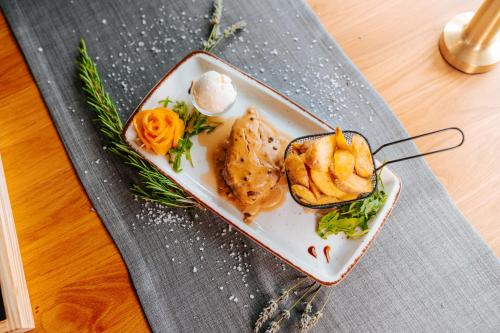 a plate of food on a table at Hotel GOLD JET Bihać in Bihać