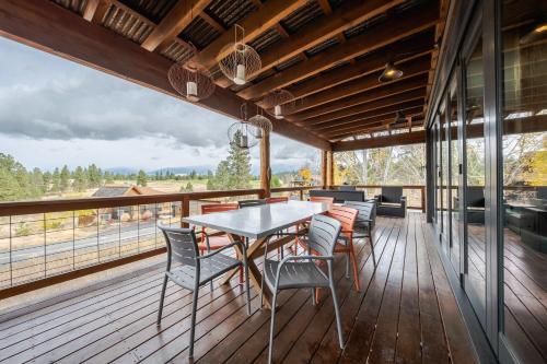 a dining room with a table and chairs on a deck at Treehouse at the Wilderness Club in Eureka