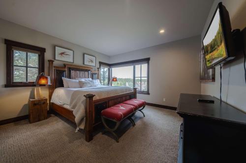 a bedroom with a bed and a flat screen tv at Treehouse at the Wilderness Club in Eureka