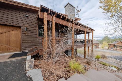a wooden house with a porch and a building at Treehouse at the Wilderness Club in Eureka