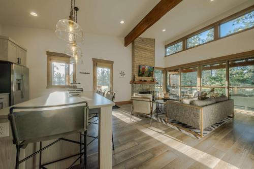a kitchen and living room with a table and a couch at Wilderness Club Cabin - Sleeps 7 in Eureka