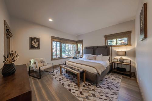 a bedroom with a large bed and a chair at Wilderness Club Cabin - Sleeps 7 in Eureka