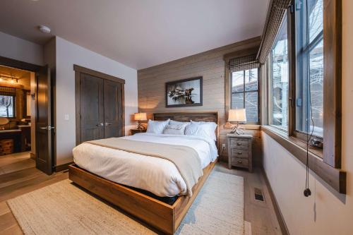 a bedroom with a large bed and windows at Wilderness Club Cottage on 18th Green in Eureka