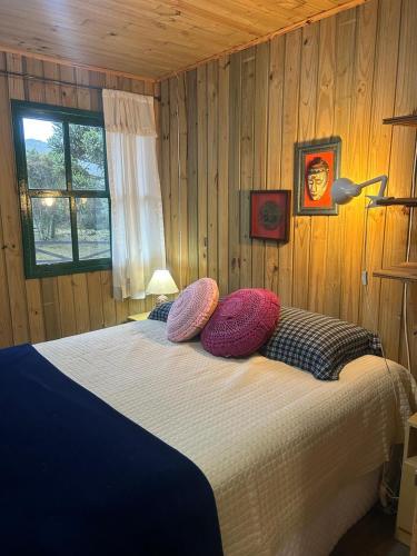 a bedroom with a bed with pillows on it at Estalagem Carucacas in Bom Jardim da Serra