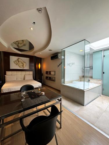 une chambre avec un lit et une douche et un bureau dans l'établissement Lumini Motel, à São Paulo