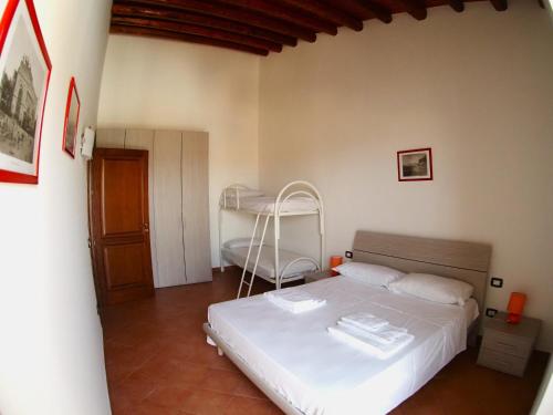 a bedroom with a white bed and a desk at Residenza Marconi's Nest in Siculiana