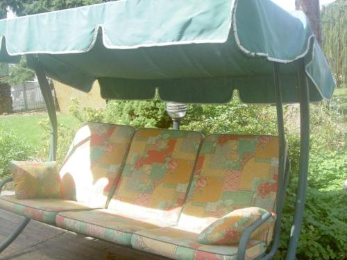 a chair under an umbrella on a patio at by the forest Modern retreat in Tharandt