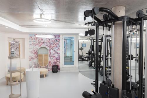 a gym with lots of treadmills and a bunch of exercise equipment at Hotel Traube Revital in Wurmlingen