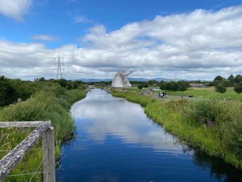 a river with a statue on the side of it at Caledonia House in Rosyth