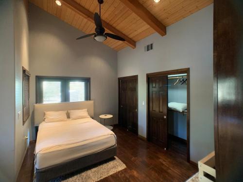 a bedroom with a bed and a ceiling fan at Ranch stay near Sequoias in Woodlake