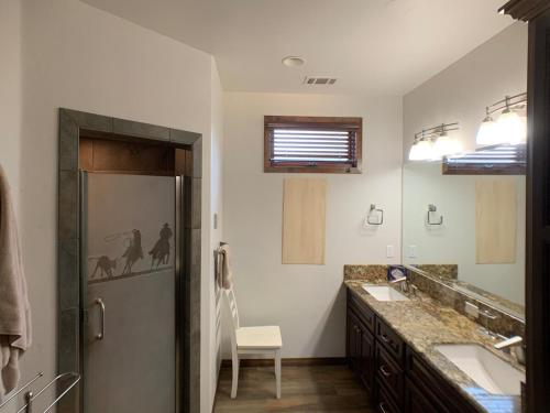 a bathroom with a shower and a sink and a mirror at Ranch stay near Sequoias in Woodlake