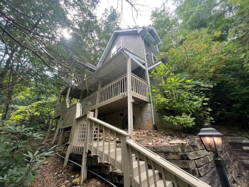 a tree house with stairs leading up to it at Secluded Cabin for 10 in Chalet Village and Hot Tub in Gatlinburg