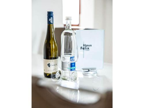 two bottles of wine sitting on top of a counter at "Spitzhausblick" in het Huis Felix in Radebeul