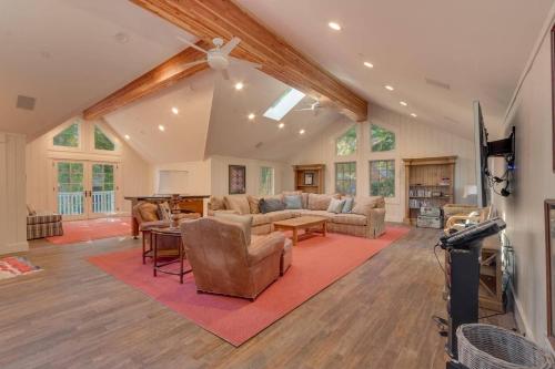 a living room filled with furniture and a tv at Belleview Lakefront by Tahoe Getaways - Hot Tub, Pier, Buoy and Guest House in Homewood