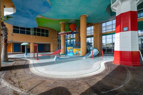 an empty playground in a building with a slide at Beachfront Haven 2 BDR Kid-Friendly Resort in Panama City Beach