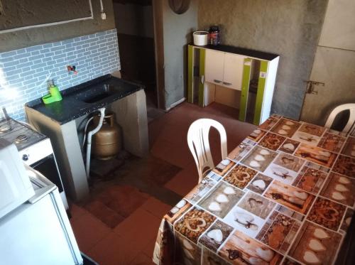 a kitchen with a table and a counter and a sink at Dunymar Apartamento in Melo