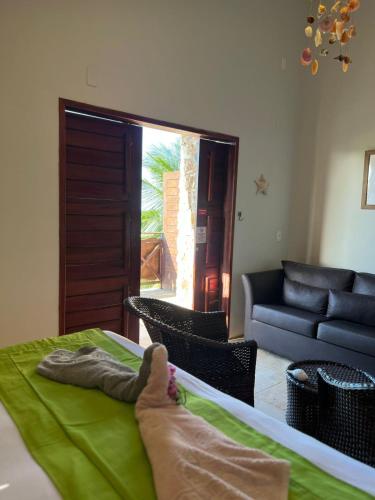 a person laying on a bed in a room at The Wind Village in Itarema