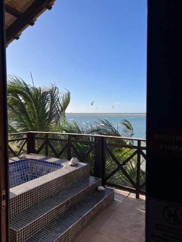 a view of the ocean from the balcony of a resort at The Wind Village in Itarema