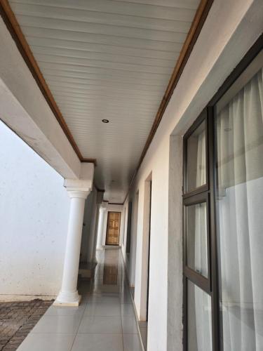 an empty hallway of a building with a column at Lido System Makonde Village in Thohoyandou
