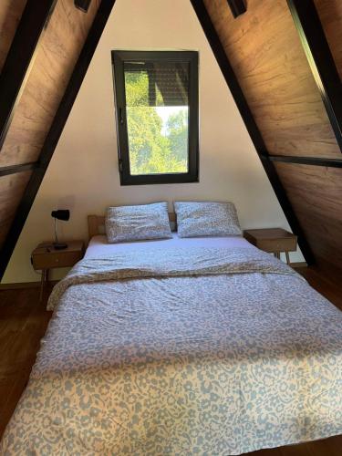 a bedroom with a bed in a attic at Villa Natura in Bosanska Gradiška