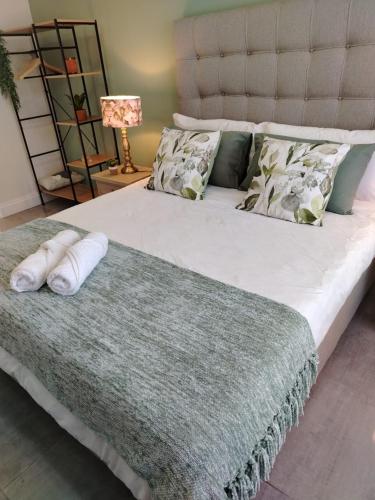 a bedroom with a large bed with pillows on it at Stay at Searle in Kirkwood