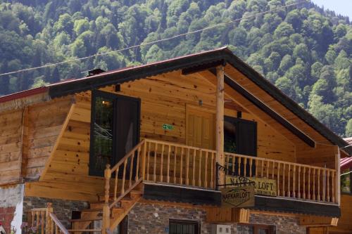a log cabin with mountains in the background at Nafkar Loft in Çamlıhemşin