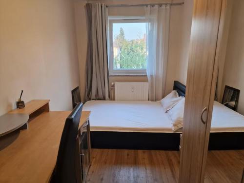 a small room with two beds and a window at Nyadjam Casa in Darmstadt