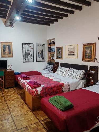 a bedroom with two beds and a television in it at Casa Chicco Parma in Parma