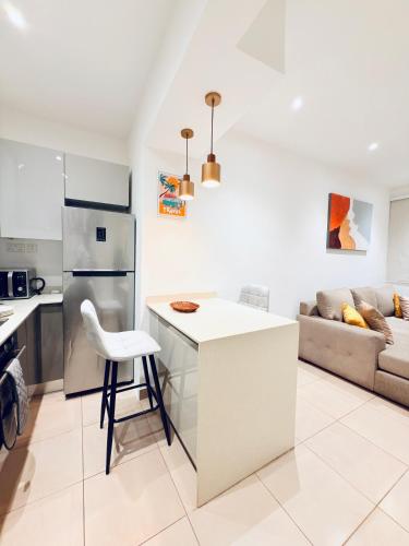 a kitchen and living room with a counter and a couch at 2 Bedroom Suite in East Legon