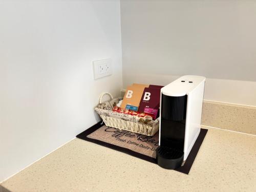 a black and white appliance on a counter with a basket of food at 300 Mbps WiFi , Netflix , Coffee machine , Tambuli in Lapu Lapu City