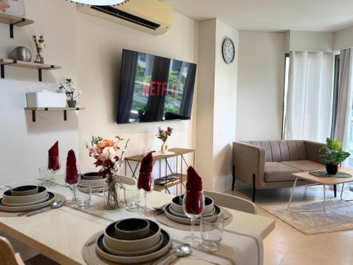a living room with a table and a couch at 300 Mbps WiFi , Netflix , Coffee machine , Tambuli in Lapu Lapu City