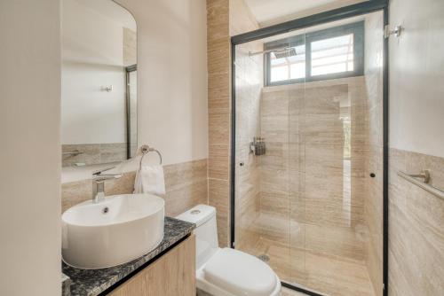 a bathroom with a toilet and a sink and a shower at Myla Chapultepec in Mexico City