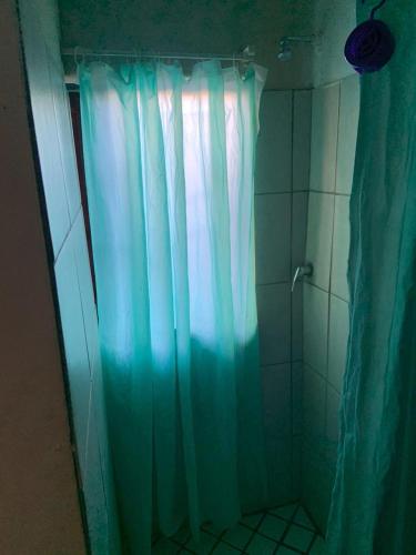 a shower with a blue shower curtain in a bathroom at Epizone in Mokopane