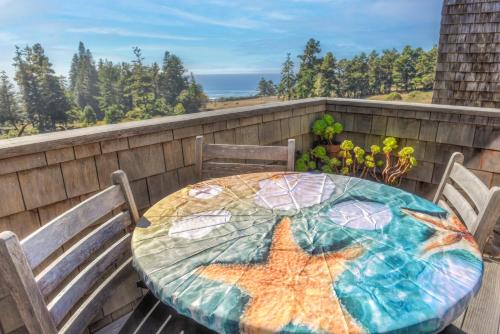 a table with a star fish painted on it on a balcony at Architectural Treasure - Private Hot Tub in Sea Ranch