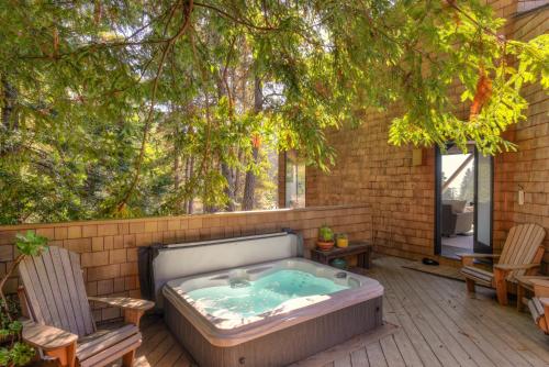 a hot tub sitting on a patio with two chairs at Architectural Treasure - Private Hot Tub in Sea Ranch