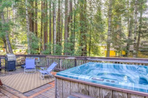 a hot tub on a deck with chairs and a grill at Searenity by the Sea - Private Hot Tub in Gualala