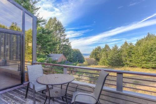 a balcony with a table and chairs and a view at Riverview - Private Hot Tub - Sleeps 12 in Sea Ranch